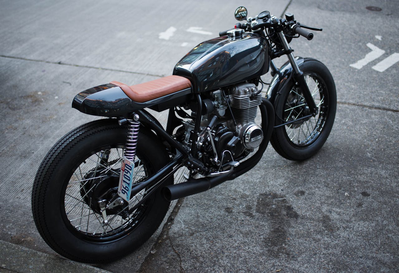 services-02 Retro-style motorcycle parked on an urban street, showcasing a classic design.